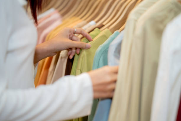 istock Close-Up of Consumer Picking Clothes on Rack 2149130420