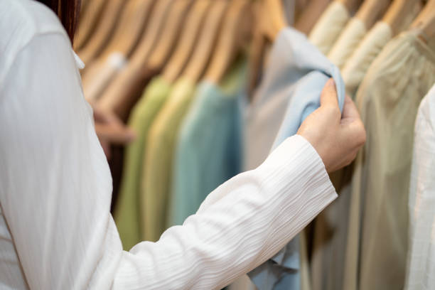 istock Close-Up of Consumer Picking Clothes on Rack 2149130424