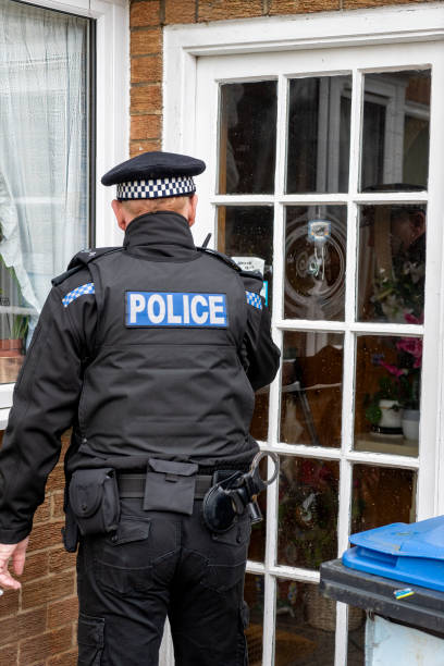 istock A policeman entering an elderly person's home. 2149130588