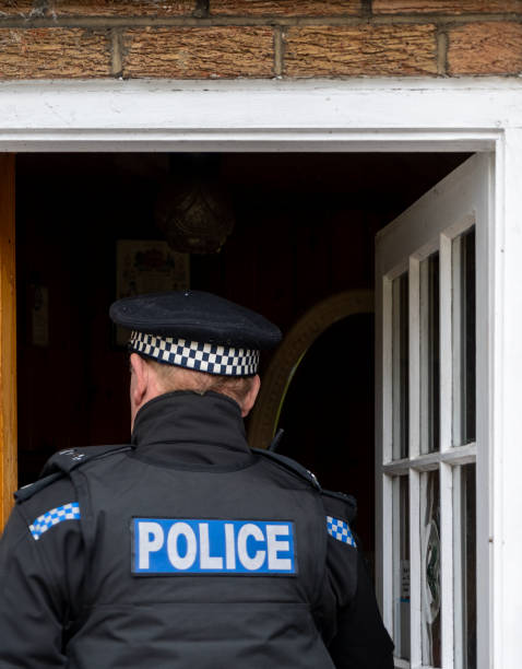 istock A policeman entering an elderly person's home. 2149130602