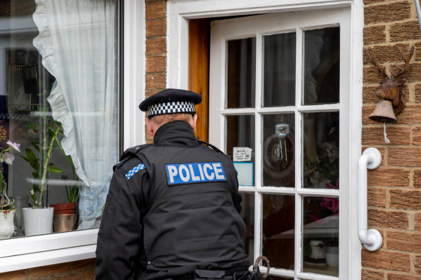 istock A policeman entering an elderly person's home. 2149130628