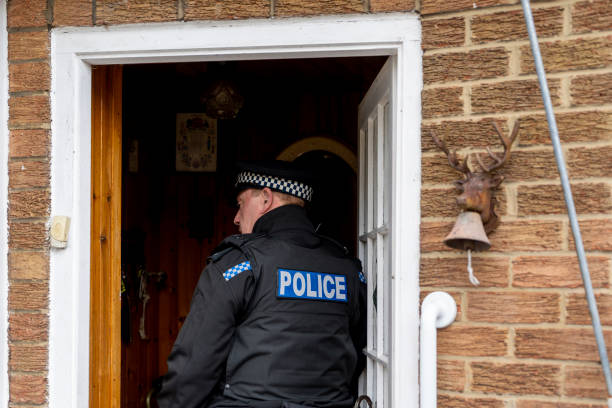 istock A policeman entering an elderly person's home. 2149130647