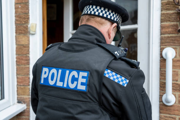 istock A policeman entering an elderly person's home. 2149130920
