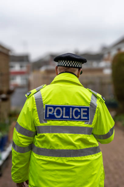 istock A policeman walking away from an elderly person's home. 2149131143