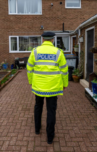 istock A policeman walking towards an elderly person's home. 2149131396