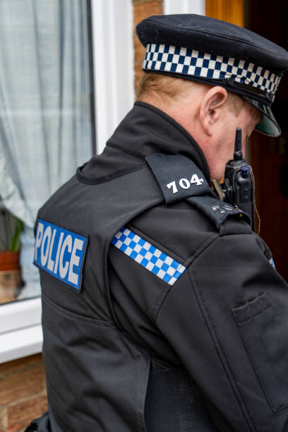 istock A policeman entering an elderly person's home. 2149131437