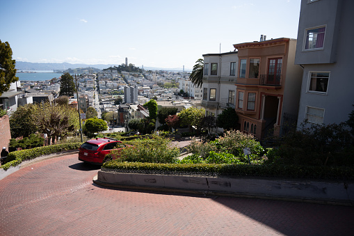 Car going down Lombard street in San Francisco during springtime day