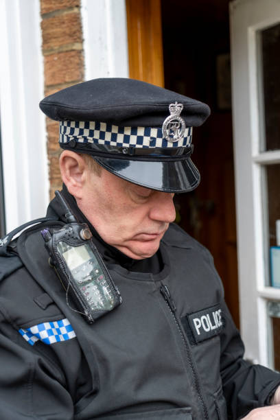 istock A policeman entering an elderly person's home. 2149131601