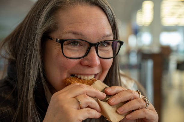 istock Beautiful mature woman eating 2149131695