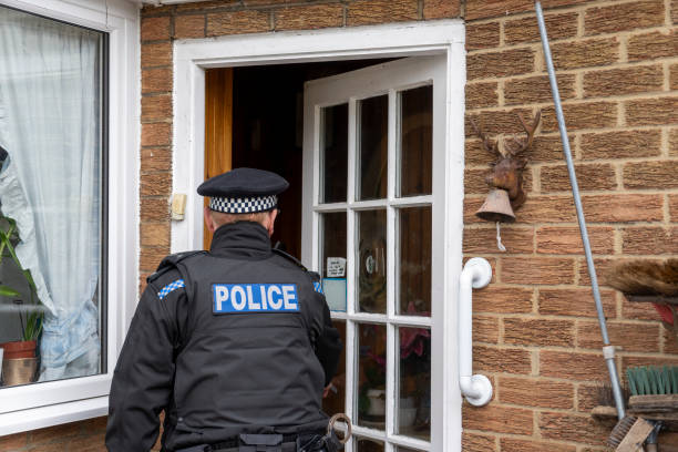 istock A policeman entering an elderly person's home. 2149131743