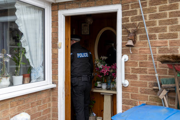 istock A policeman entering an elderly person's home. 2149131758