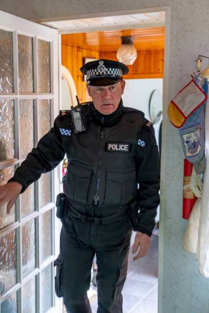 istock A policeman entering an elderly person's home. 2149131830
