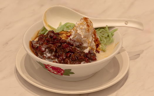 cendol dessert is made by coconut milk,ice and beans added with sugar syrub