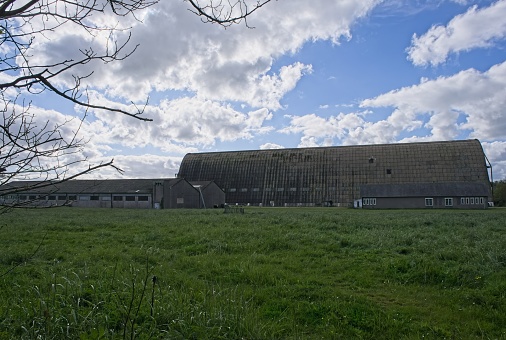 Ecausseville, France - Apr 18, 2024: First wooden hangar built between January and August 1917, when it hosted its first airship. Sunny spring day. Selective focus