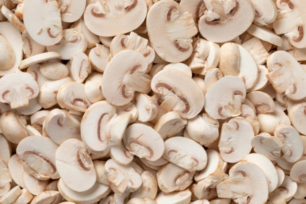 Sliced champignons, Button mushrooms,close up full frame as background