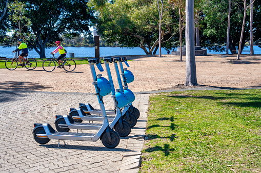 Perth, Australia - August 31, 2023: Scooter rental station in a city park.