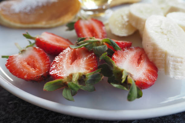 Ripe Red Strawberries in a bowl on table .