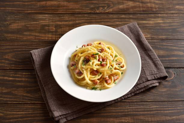 istock Carbonara pasta, spaghetti with crisp pancetta and black pepper 2149137844