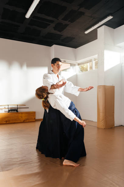 istock Man and Woman Practicing Martial Arts in Room 2149138819