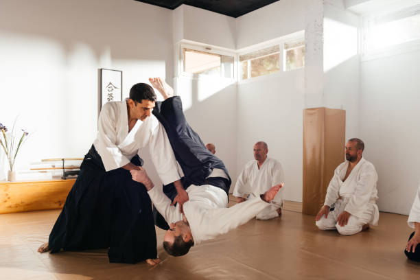 istock Martial Arts Instructor Demonstrating Aikido Throw Technique in Dojo 2149138877
