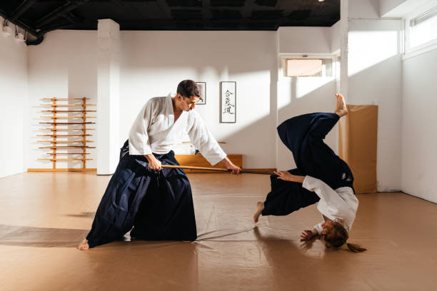 istock Aikido Practitioner Demonstrates Jo Staff Technique in Traditional Dojo Setting 2149138928