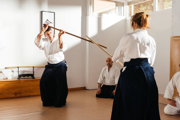 istock Martial Arts Instructors Demonstrating Jo Wooden Staff Techniques 2149139144