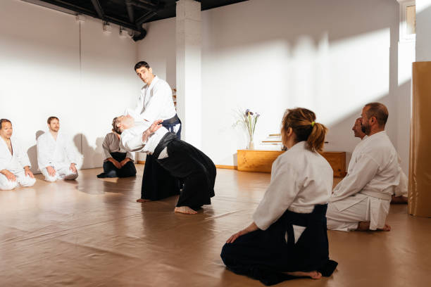 istock Martial Arts Sensei Demonstrates Technique to Attentive Students in Traditional Dojo Setting 2149139255