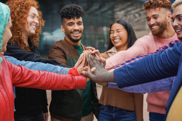 istock Multiracial young friends stacking hands together outdoor - Diverse people and unity concept 2149139796