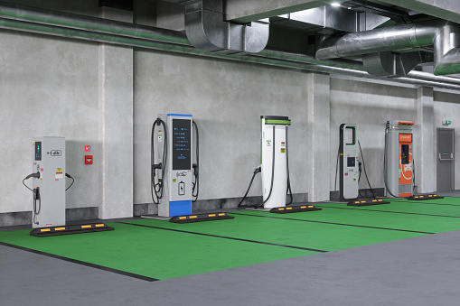 Empty Parking Garage With Different Types Of Electric Vehicle Charging Stations