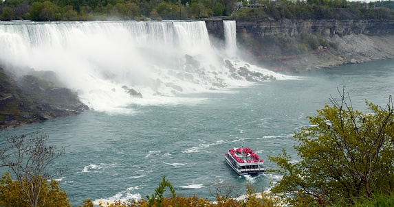 Travel on cruise ship to inexhaustible source of energy, Niagara Falls. Power and beauty of inexhaustible source witnessed firsthand on exhilarating journey. Natural energy greatness concept.