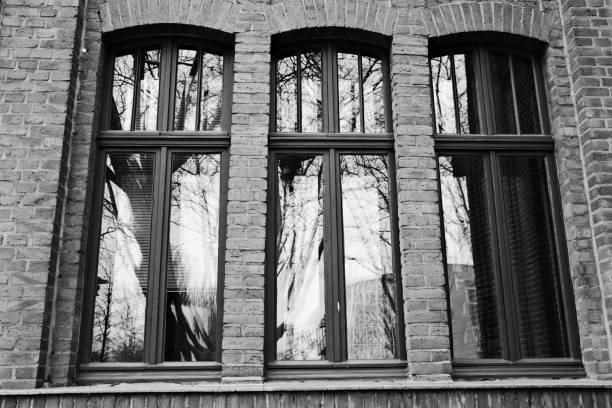 old window in a brick wall of an industrial old buiding