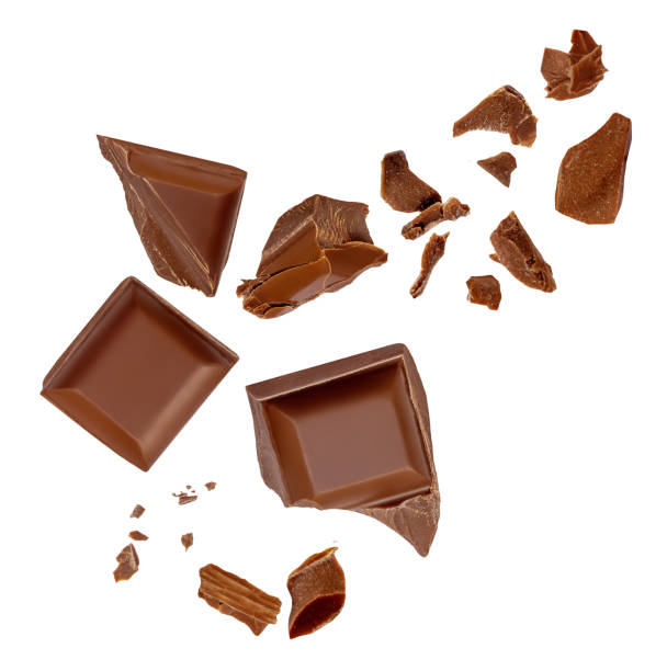 istock  Levitating milk chocolate chunks isolated on white background. Crumbs, shavings and Flying Chocolate pieces Top view. Flat lay 2149141943