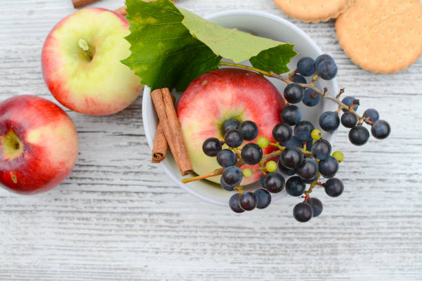 Home grown apples and grapes on wooden table