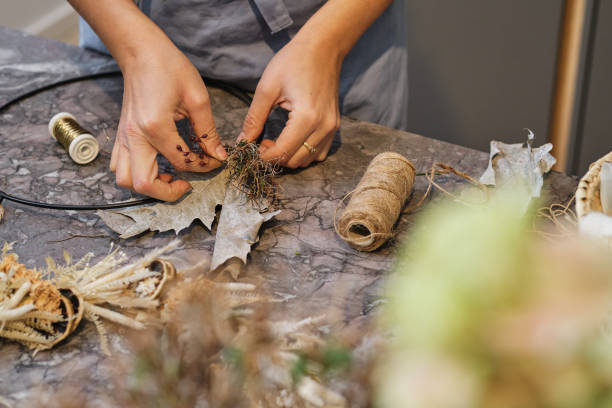 istock Crop woman in process of making floral wreath 2149143093