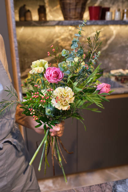 istock Crop female florist in with flower bouquet 2149143164