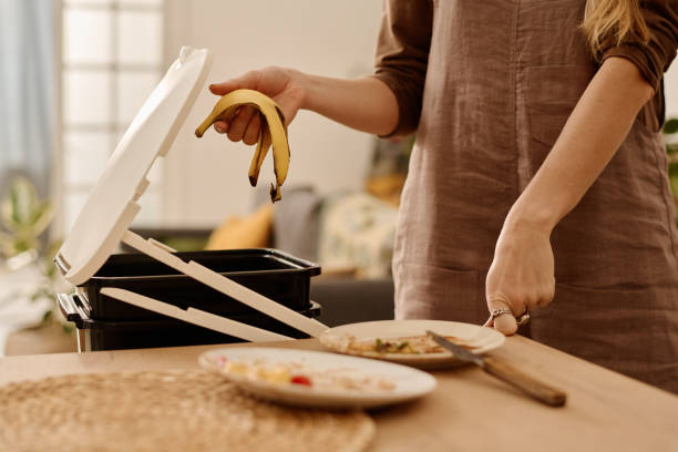 istock Holding banana peel over compost bucket 2149144420