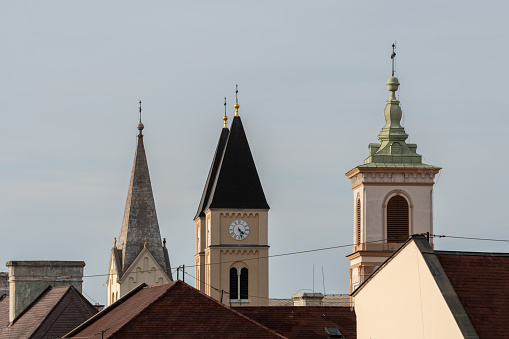 Bell towers of catholic churches in Veszprém on a sunny day.