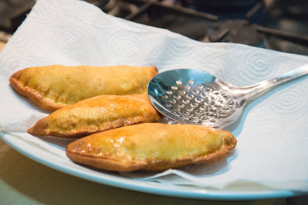Ready-made ruddy fried panzerotti, chebureks, pies