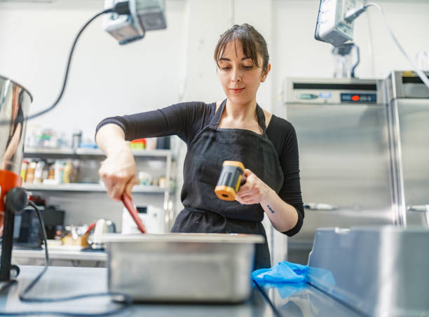 istock One female chocolatier working at the chocolate factory 2149146415