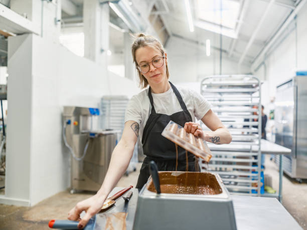 istock One female chocolatier working at the chocolate factory 2149146566