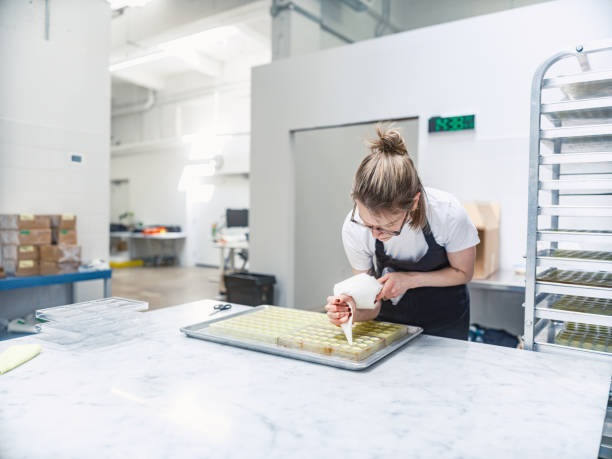 istock One female chocolatier working at the chocolate factory 2149146662