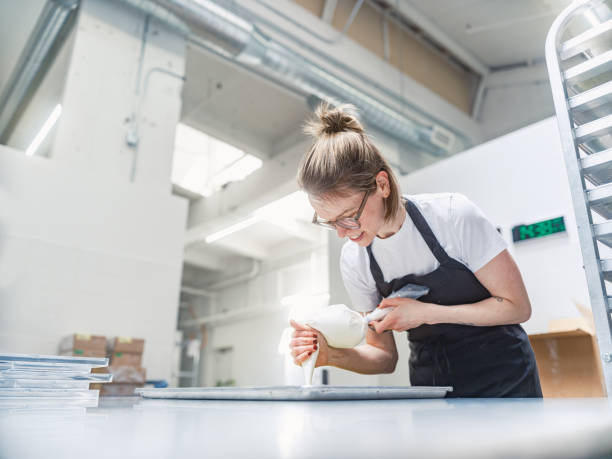 istock One female chocolatier working at the chocolate factory 2149146676