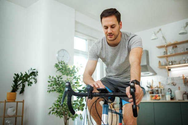 istock Handsome man doing bike workout at home 2149147230