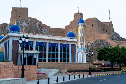 Colorful mosque against Al Jalali fort in old Muscat. Oman