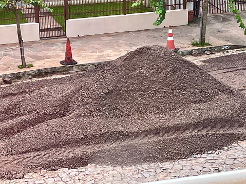 A pile of gravel piled up on a street