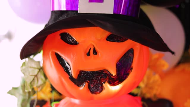 plastic pumpkin with halloween lantern shaped hat in colorful decoration