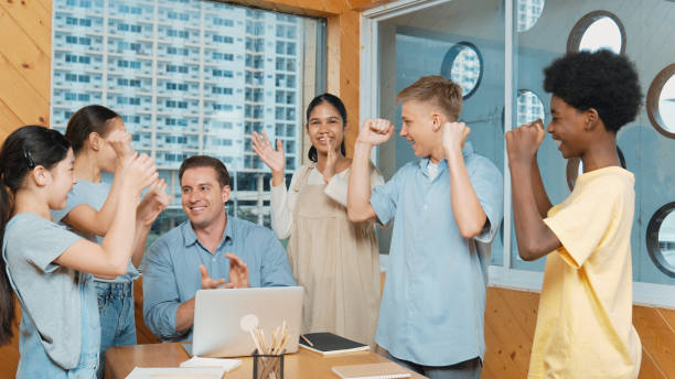 istock Teacher and student clap hand to celebrate for successful project. Edification. 2149150443