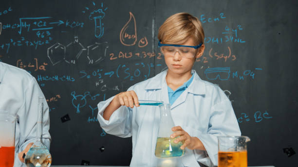 istock Caucasian teacher helps student mixed liquid in science laboratory. Erudition. 2149150951