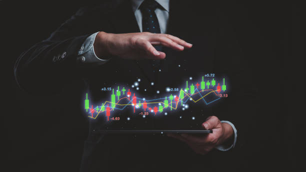 istock A man is holding a tablet with a candlestick line graph and chart. The graph is showing a stock market trend in business, financial and investment profit, loss and trend forecast concept. 2149151370