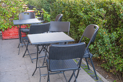 A colorful metal  folding table and chair set on a brick patio